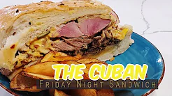 A cuban sandwich cut in half on a blue plate